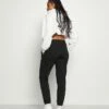 DKNY STACKED CITY LOGO HIGH RISE - Tracksuit Bottoms - Black -Bag Haven Store 20ab472c863144c4a4ea24d46dafef68