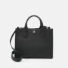 DKNY CAROL - Tote Bag - Black/gold-coloured 1 DKNY CAROL - Tote Bag - Black/gold-coloured -Bag Haven Store ae38b54d2bd2486aad65e4d604fb756b