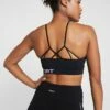 DKNY LOW IMPACT STRAPPYSEAMLESS BRA REMOVABLE CUPS - Light Support Sports Bra - Black -Bag Haven Store b396e690e11c4a8eb6544c2711992e63